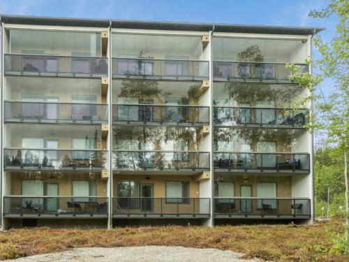 an apartment building with plants on the balconies at Holiday Home Tievan aurinkorinne dina by Interhome in Sirkka