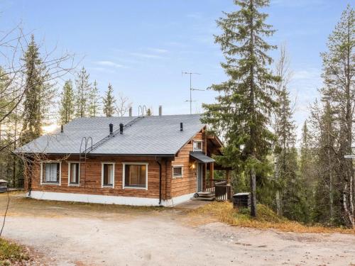 a wooden house in the middle of a forest at Holiday Home Sallan lumous a by Interhome in Salla