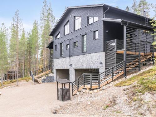 a large black house with a gambrel roof at Holiday Home Villa arcus a by Interhome in Pelkosenniemi