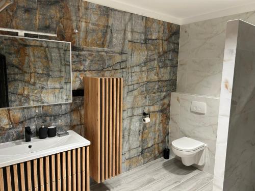 a bathroom with a toilet and a sink at Apartment Hamburg Perle in Hamburg