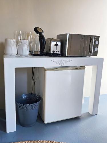a white table with a microwave on top of it at Best Place Ever in Hout Bay