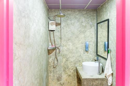 a bathroom with a sink and a shower at Slumber Party Chiang Mai in Chiang Mai