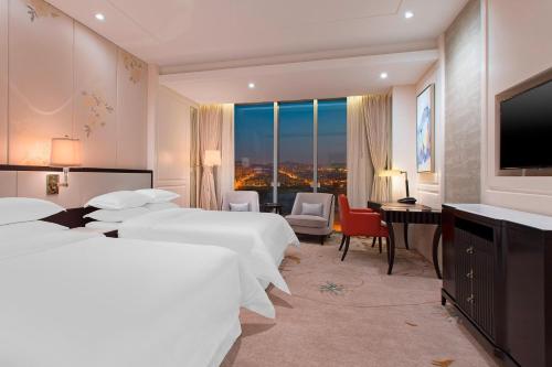 Ένα ή περισσότερα κρεβάτια σε δωμάτιο στο Sheraton Qingdao Licang Hotel