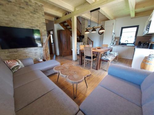 a living room with a couch and a table at CHALUPY TRI GROŠE VLAŠKY in Bešeňová