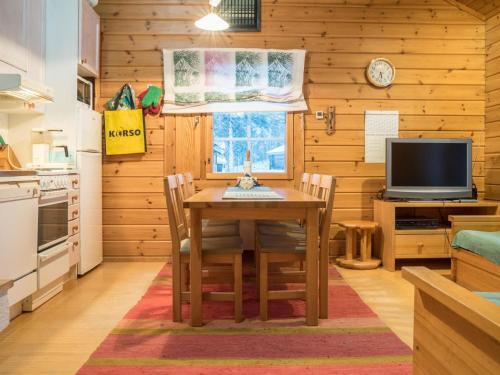 a dining room with a table and a television at Holiday Home Lomaylläs h109 -pistopolku 1 a by Interhome in Ylläsjärvi