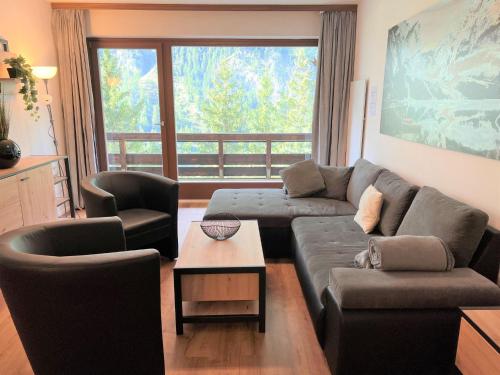a living room with a couch and two chairs at Apartment Top 49 by Interhome in Heiligenblut