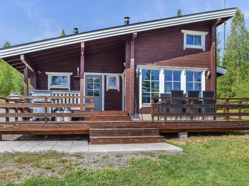 a log cabin with a large porch and benches at Holiday Home Lekojärven herra by Interhome in Räihä