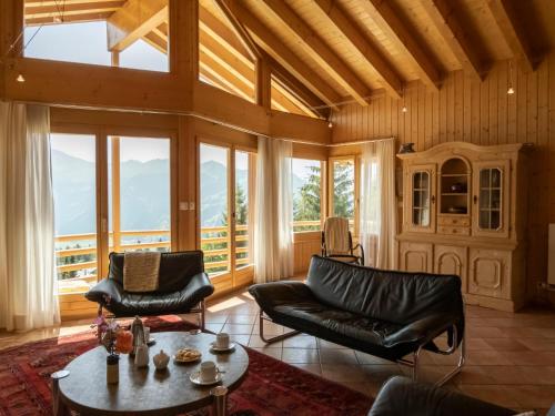 a living room with a couch and a table at Holiday Home Midat Soleil by Interhome in Verbier