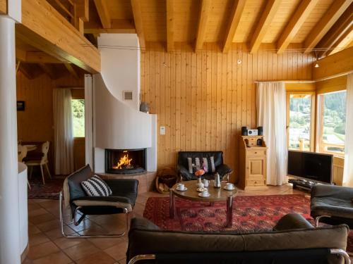 a living room with a couch and a fireplace at Holiday Home Midat soleil by Interhome in Verbier