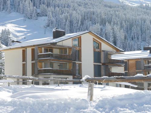 a house in the snow in the mountains at Apartment Triangel Raber by Interhome in Parpan