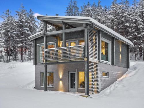 a house in the snow in the woods at Holiday Home Villa ukkohalla by Interhome in Ukkohalla