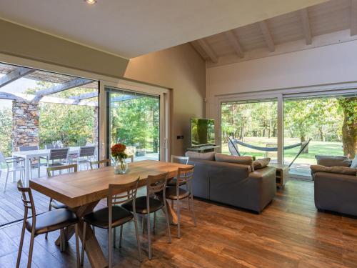 a living room with a wooden table and a couch at Holiday Home Motto dei Dossi by Interhome in Albonico