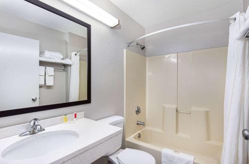 a bathroom with a sink and a toilet and a shower at Microtel Inn and Suites by Wyndham - Cordova in Memphis