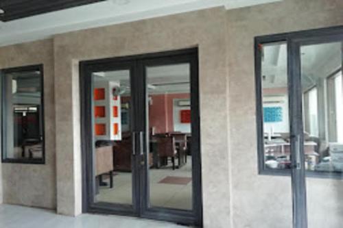 a room with two glass doors and a living room at Hotel Park Regency in Gorakhpur