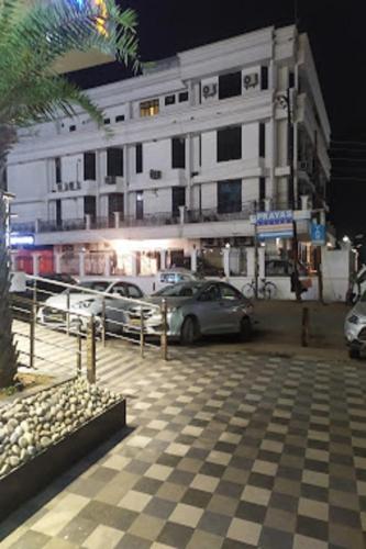 a parking lot with cars parked in front of a building at Hotel Park Regency in Gorakhpur