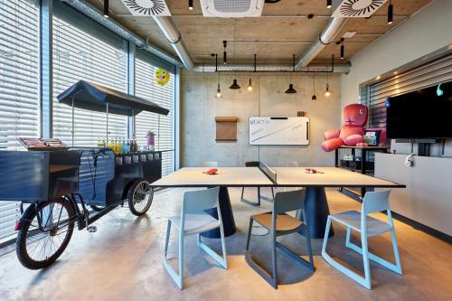a room with a table and a bike in it at Moxy Karlsruhe in Karlsruhe