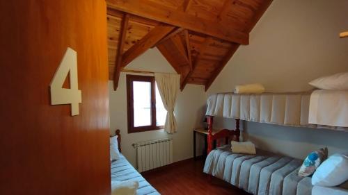 a bedroom with two bunk beds and a window at MERMOZ in El Chalten