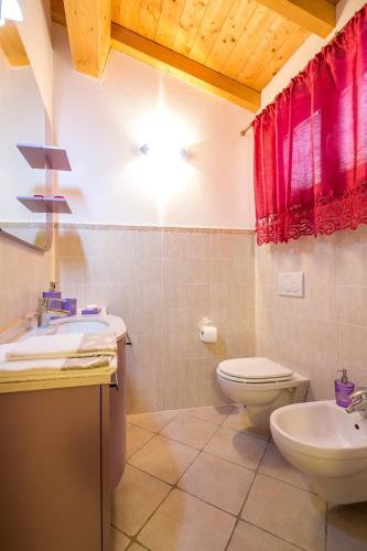 a bathroom with a toilet and a sink at Borgo dell'Uccellaia - Turchese - Giada in Marciana Marina