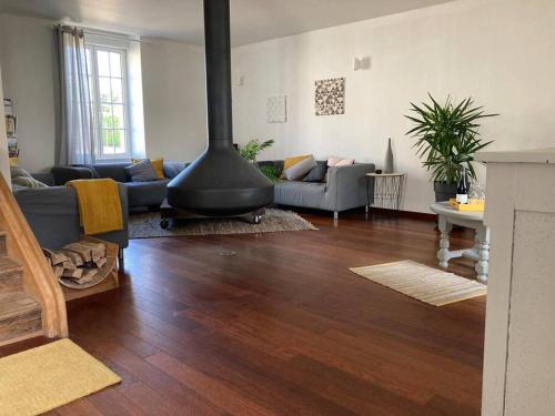 a living room with a fire place in the middle at 38BIS Location nuit / week-end / vacances in Chaignay