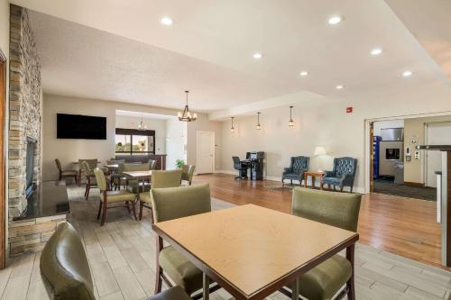 a dining room and living room with tables and chairs at Quality Inn Tulsa Central in Tulsa