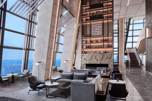 a lobby with couches and chairs and a fireplace at JW Marriott Hotel Xi'an in Xi'an