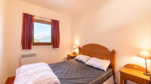 a bedroom with a bed with two pillows on it at La Turra 410 - Appt pres des pistes 6 pers in Modane