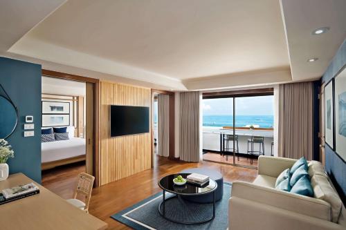 a living room with a couch and a table at Avani Pattaya Resort in Pattaya Central