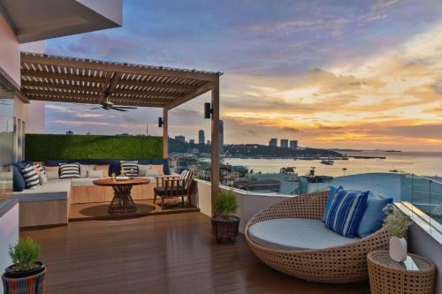 a balcony with a view of the water at Avani Pattaya Resort in Pattaya