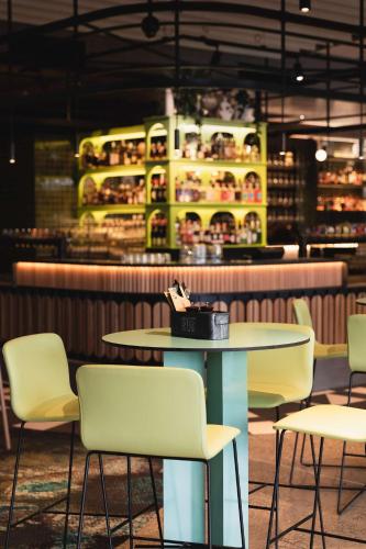 a table and chairs in front of a restaurant at Nightelier Mitchelton The Brook in Brisbane