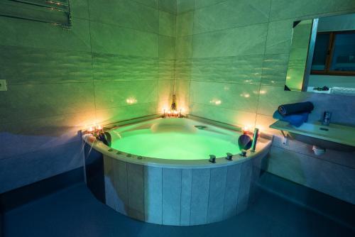 a bathroom with a tub with lights in it at Apartamentos Spa Las Caldas y Spa El Balneario in Oviedo