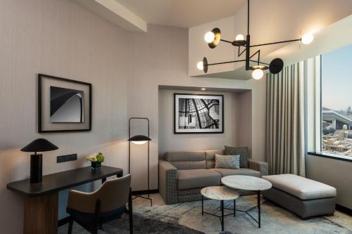 a living room with a couch and a table at Sheraton Mall of the Emirates Hotel, Dubai in Dubai