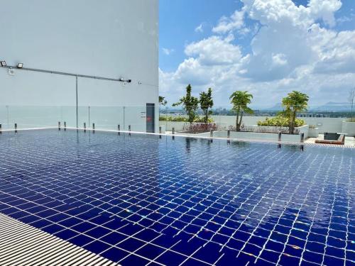 a swimming pool with blue tiles on the water at The Podium-3R2B-Free 2 Parking-12 Pax-D321 in Kuching