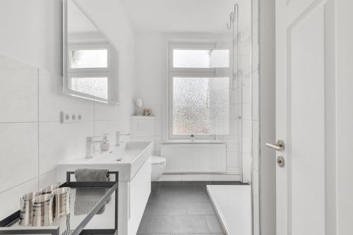 a white bathroom with a sink and a toilet at Altstadt-Refugium Goslar in Goslar