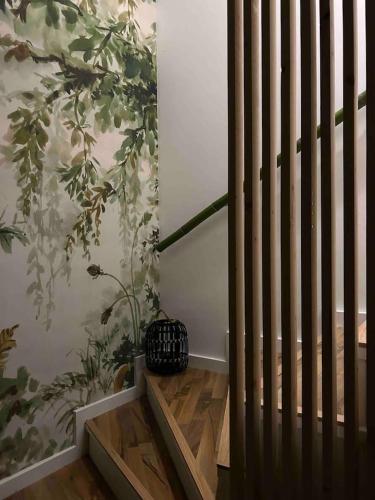 a room with a staircase with a plant on the wall at the green nest in Olginate
