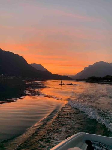a boat is on the water at sunset at the green nest in Olginate