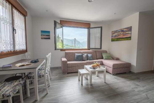 a living room with a couch and a table at Apartamentos Spa Las Caldas y Spa El Balneario in Oviedo