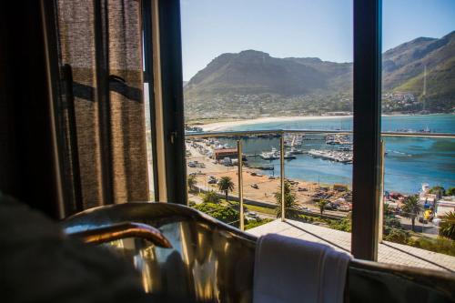 a room with a view of a beach and the ocean at Best Place Ever in Hout Bay
