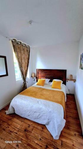 a bedroom with a large bed with yellow pillows at Domaine de Cachaou Villa Leyr'ial sauna & spa in Salles