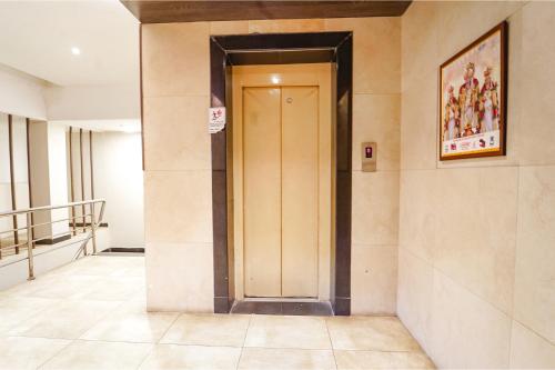a hallway with a door in a building at FabHotel Karpagam - 900m from Nehru Stadium in Coimbatore