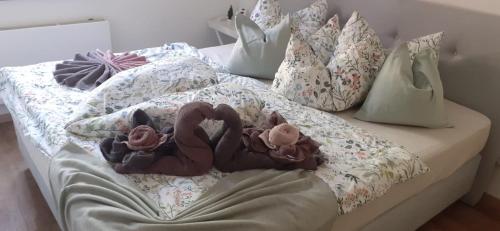 a bed with stuffed animals on top of it at FeRo´s Ferienwohnung in Wernigerode