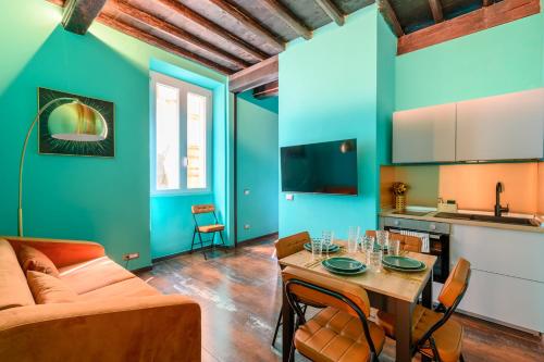 a living room with a table and a couch at Riad De’ Fiori in Rome