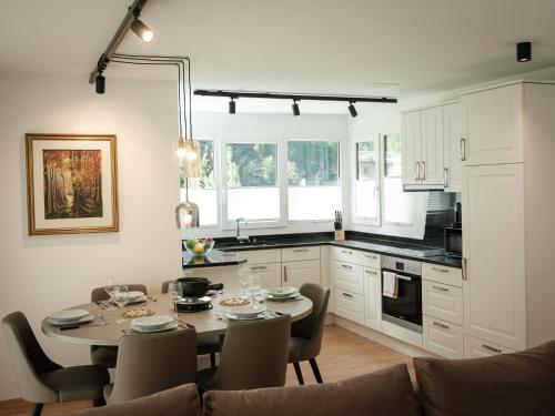 a kitchen and dining room with a table and chairs at Apartment Davinci by Interhome in Täsch