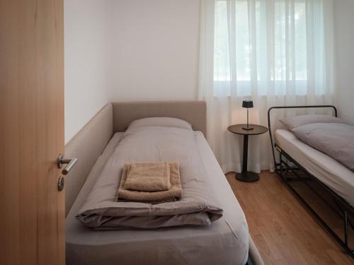 a bedroom with two beds and a window at Apartment Davinci-2 by Interhome in Täsch