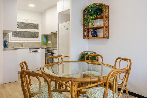 a dining room with a glass table and chairs at Aubi in Palamós
