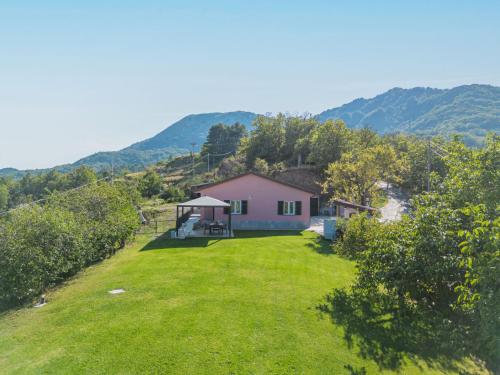 a house on a hill with a green yard at Holiday Home La Mela Musona by Interhome in Maissana