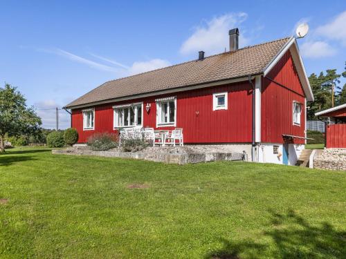 a red and white house with a green yard at Holiday Home Ryedal by Interhome in Svängsta