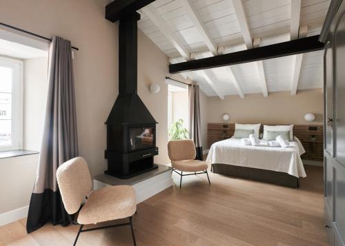 a bedroom with a bed and a wood stove at El Amparo de Narcisa 