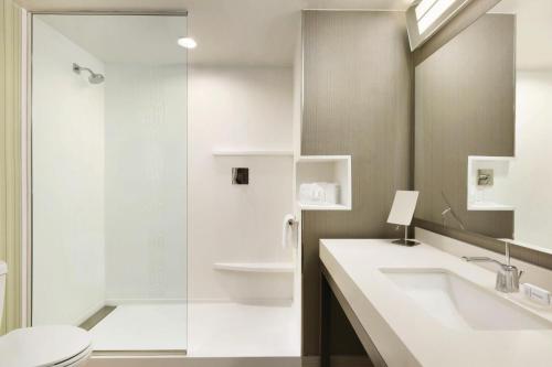 a bathroom with a toilet and a sink and a shower at Courtyard by Marriott El Paso East/I-10 in El Paso