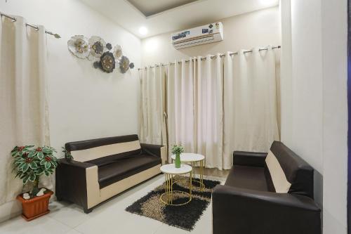 a living room with a couch and a table at FabHotel Paradise Stay Inn in Nagpur