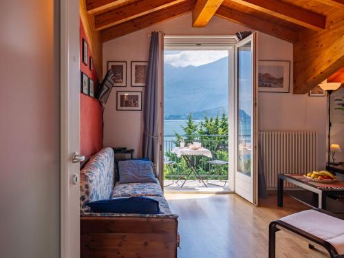 a living room with a couch and a view of the ocean at Apartment Serenella by Interhome in Gravedona